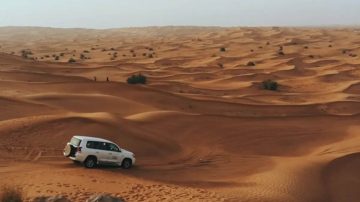 Desert safari at sunset in Dubai in November, with a 4x4 on the red dunes