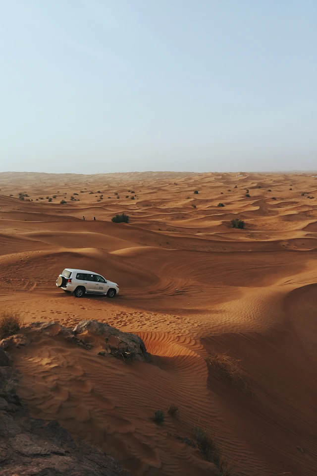 4x4 Land Cruiser dune bashing desert safari Dubai UAE red sand dunes